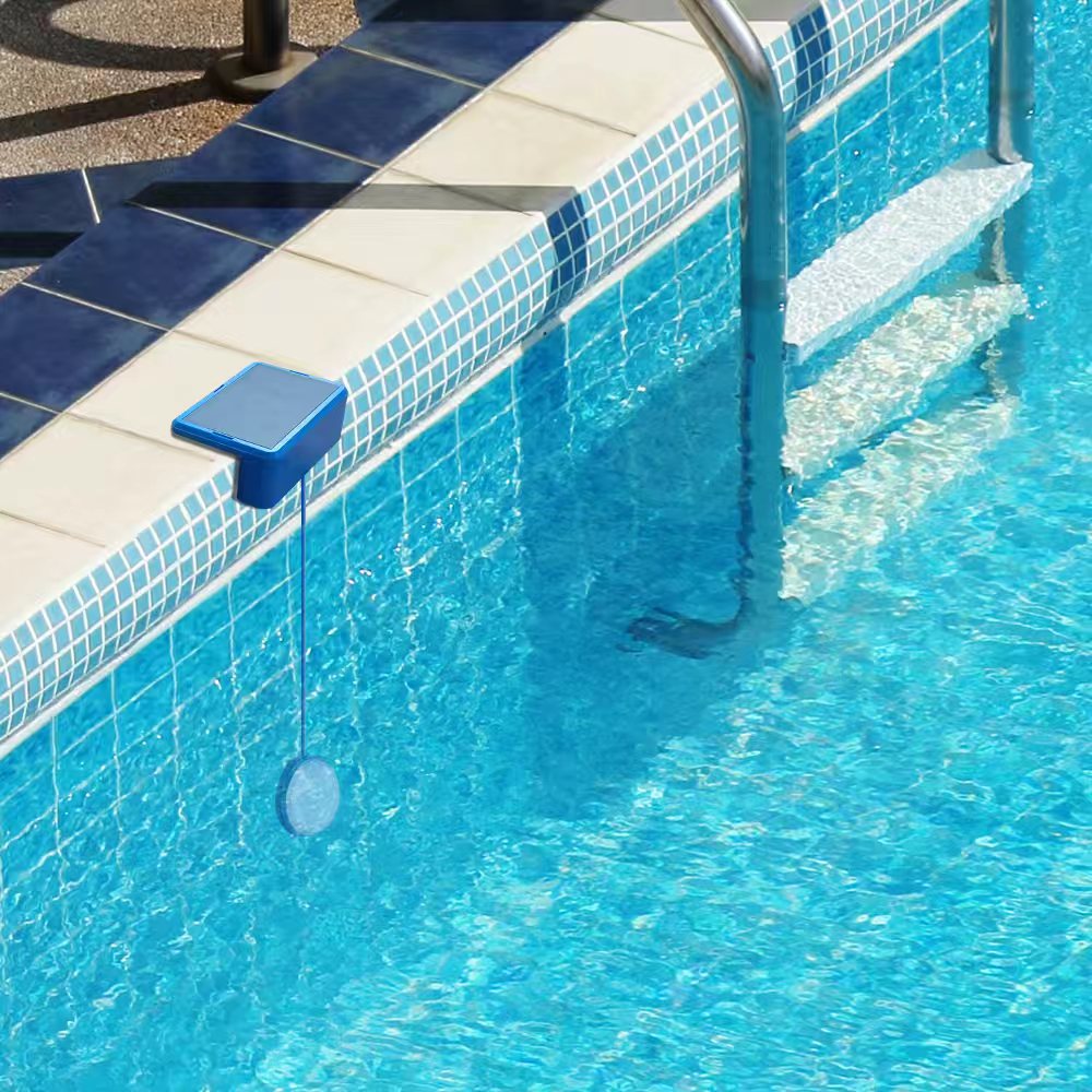 Solar swimming pool light installed on pool edge illuminating underwater